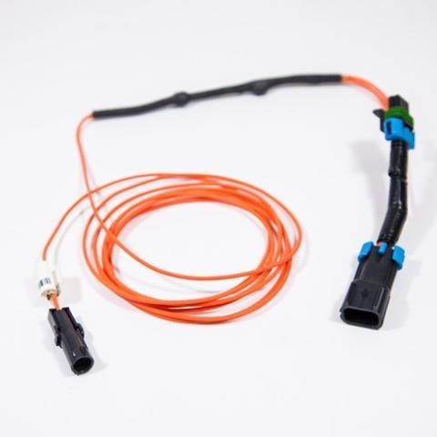 Orange fiber optic cable with black connectors and a small white connector on a plain background