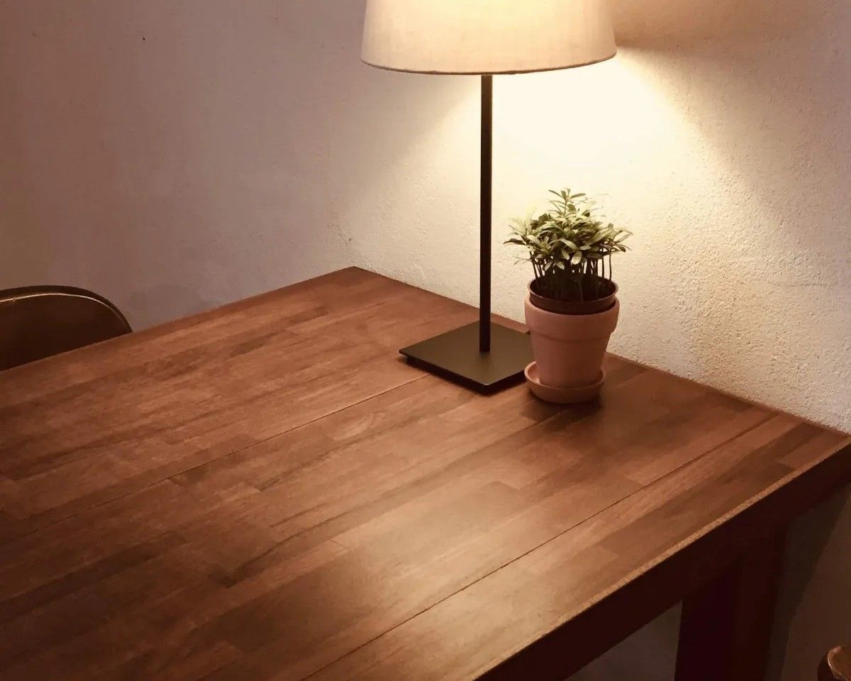 Live-edge wood coffee table with turquoise resin inlay and black metal legs indoors