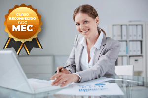 Woman at desk with laptop smiling,