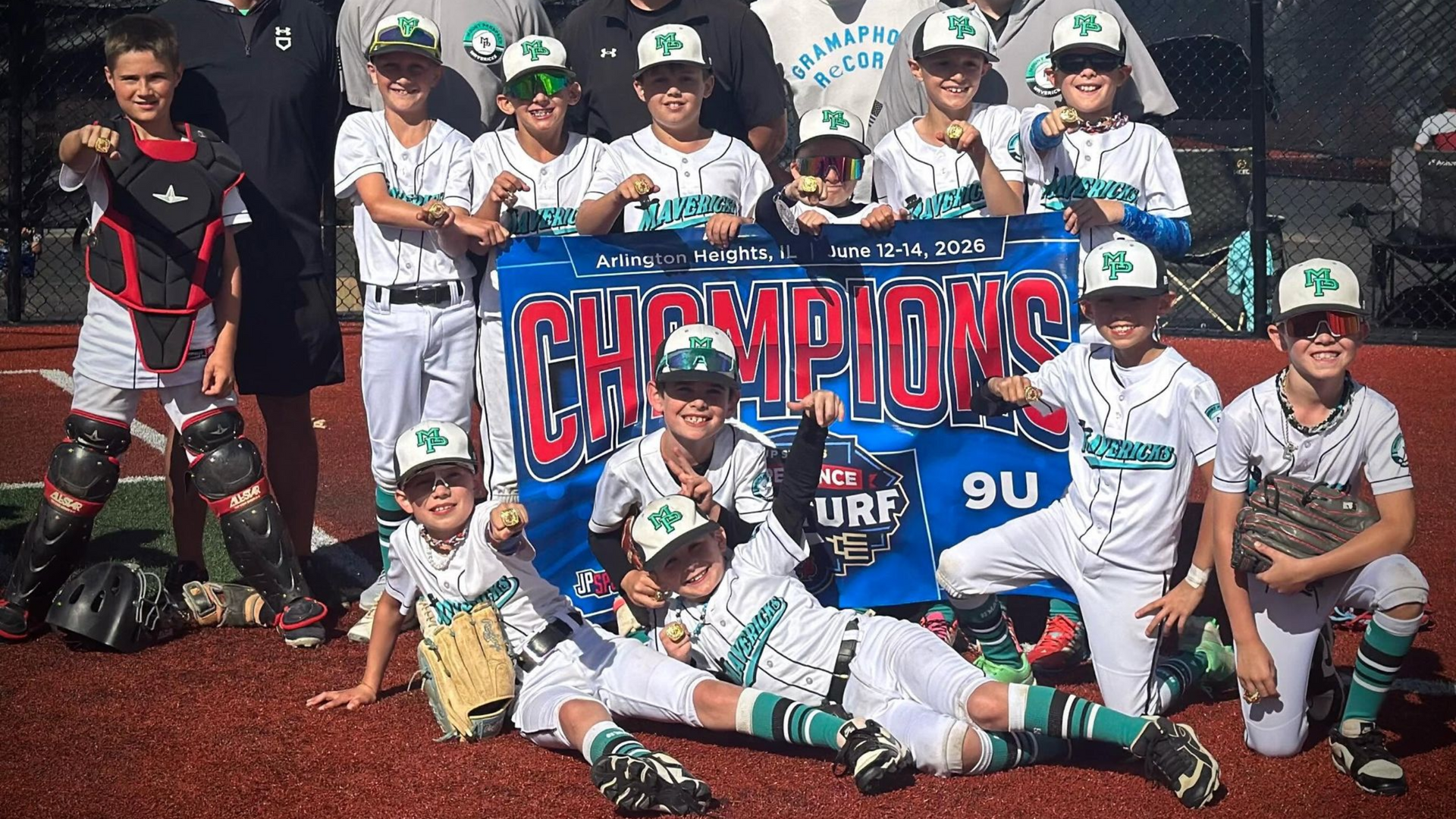 Mavericks 9U team with their championship banner