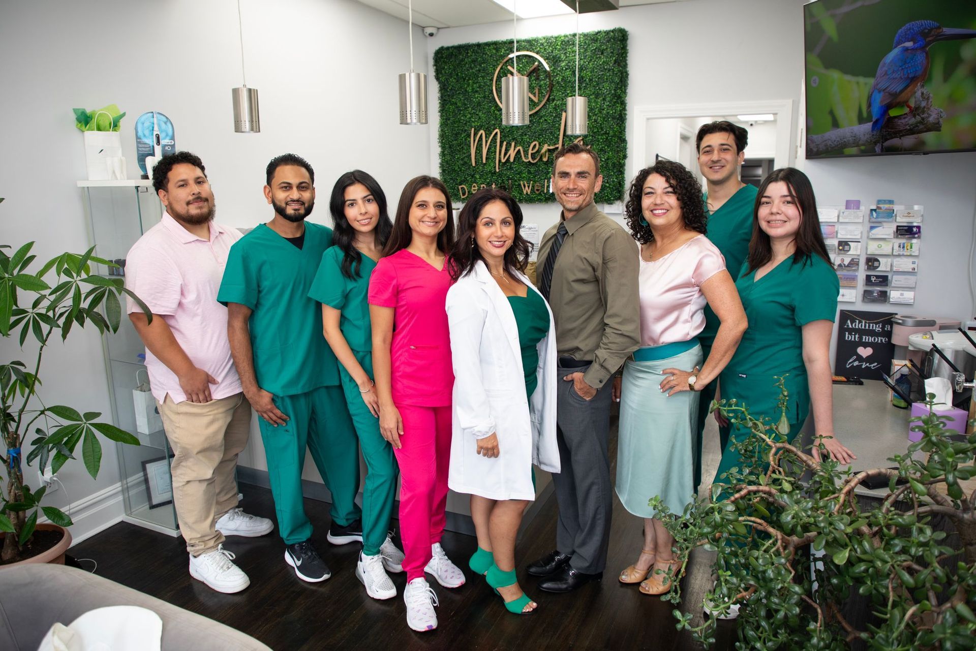 A group of people are posing for a picture in a room. - mercury free dentist