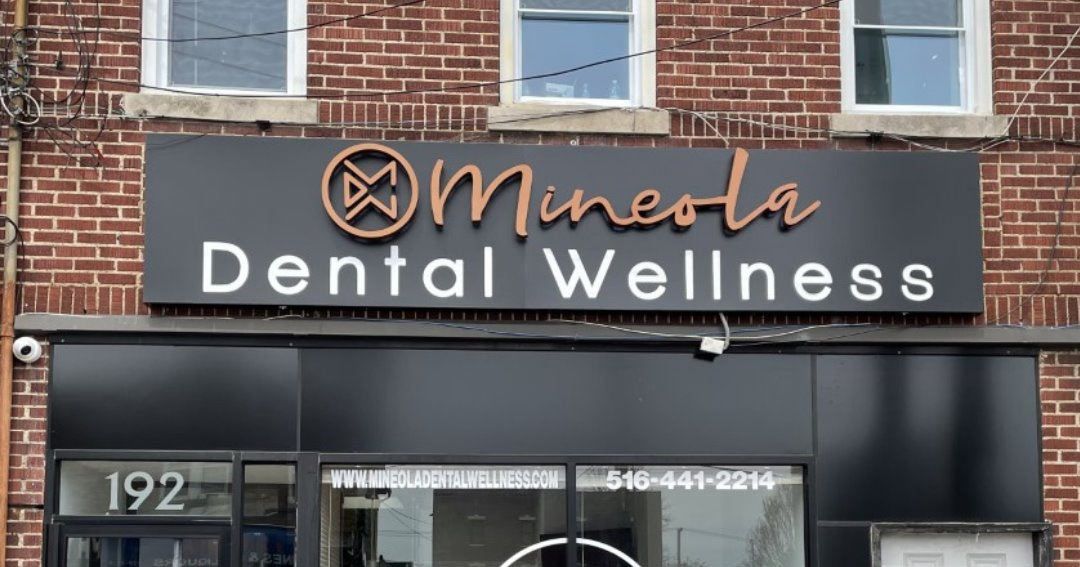 A brick building with a sign that says minneola dental wellness