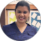 A woman in a blue shirt is smiling in a circle.