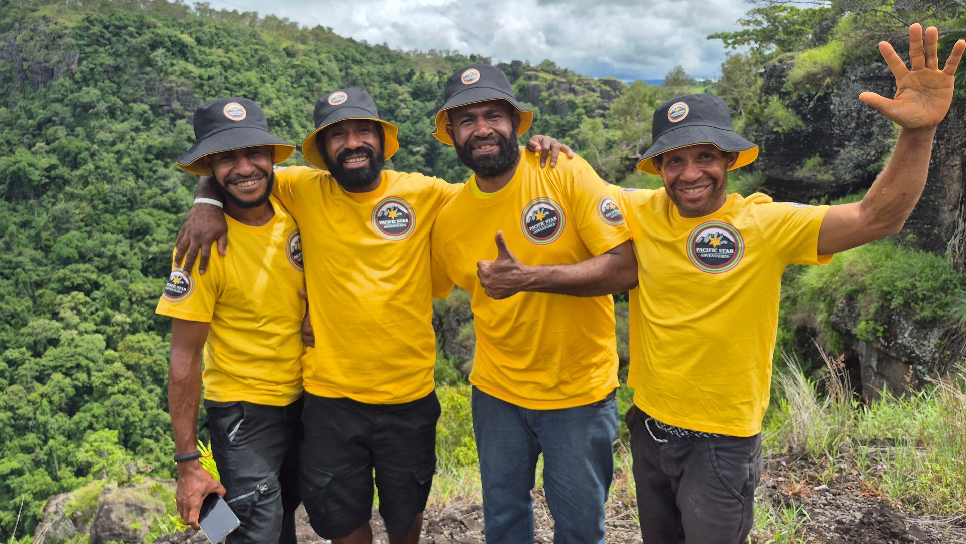 Five people standing in group and smiling at camera on the Kokoda trail in Papua New Guinea