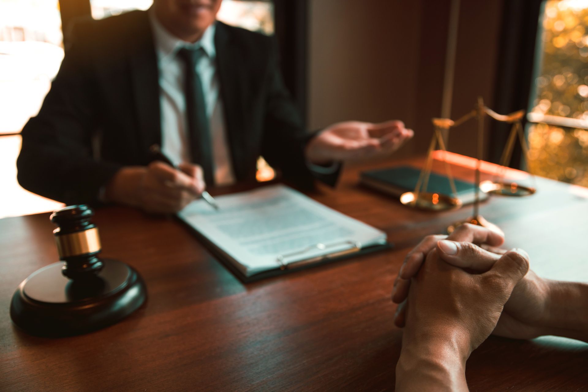 Lawyer discussing a client's trial while reviewing documents at a desk