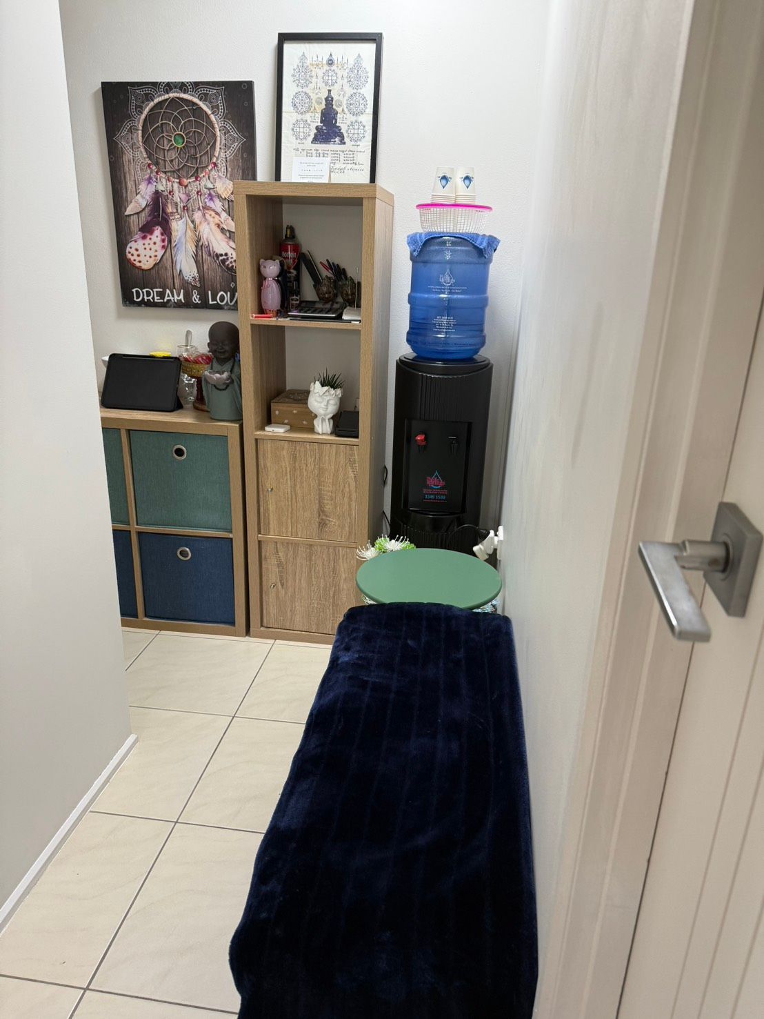 A corner of a massage room with a water cooler at Sarah's Thai Massage Paradise Point.