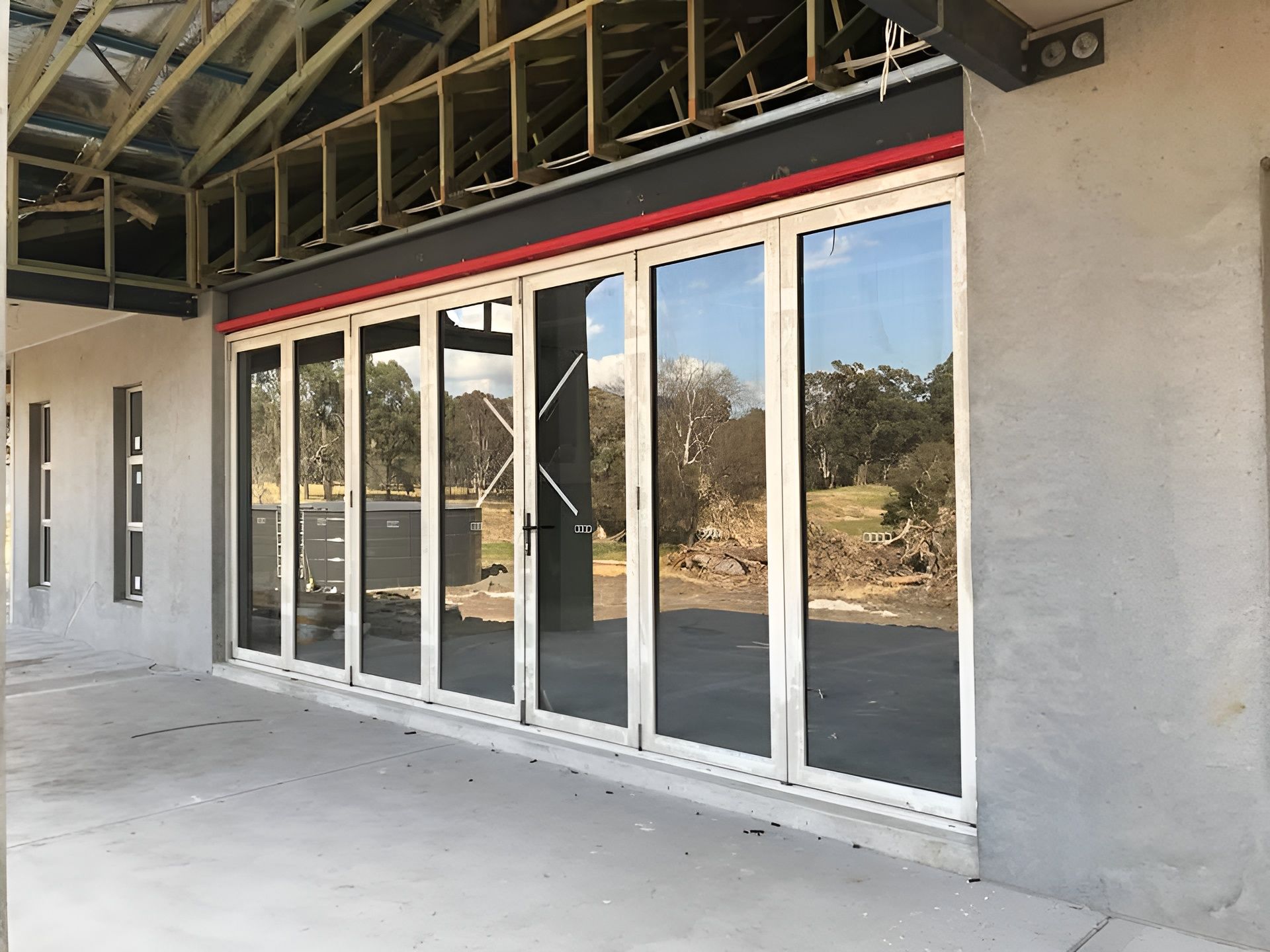 Exterior View of A Building with Large, Folding Glass Doors — Master Glass & Glazing in Belmont, NSW