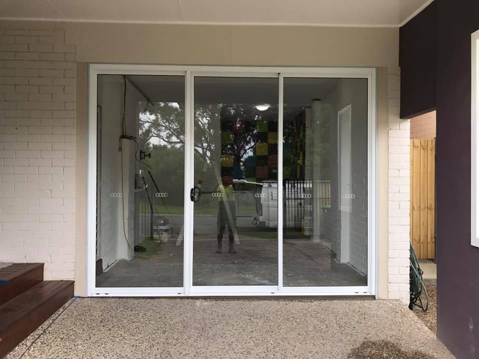 Sliding Glass Doors with White Frame, Outdoor Patio Setting — Master Glass & Glazing in Merewether, NSW