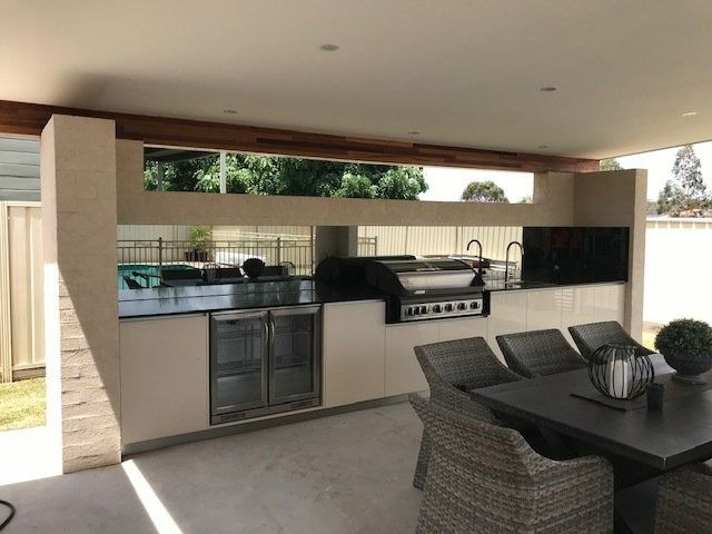 Outdoor Kitchen with Stainless Steel Appliances, Black Countertop — Master Glass & Glazing in Newcastle, NSW