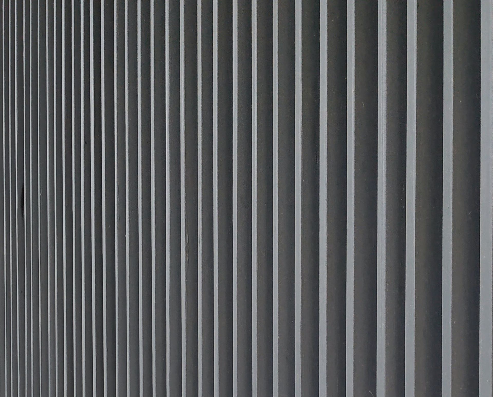Gray vertical blinds with alternating light and dark slats