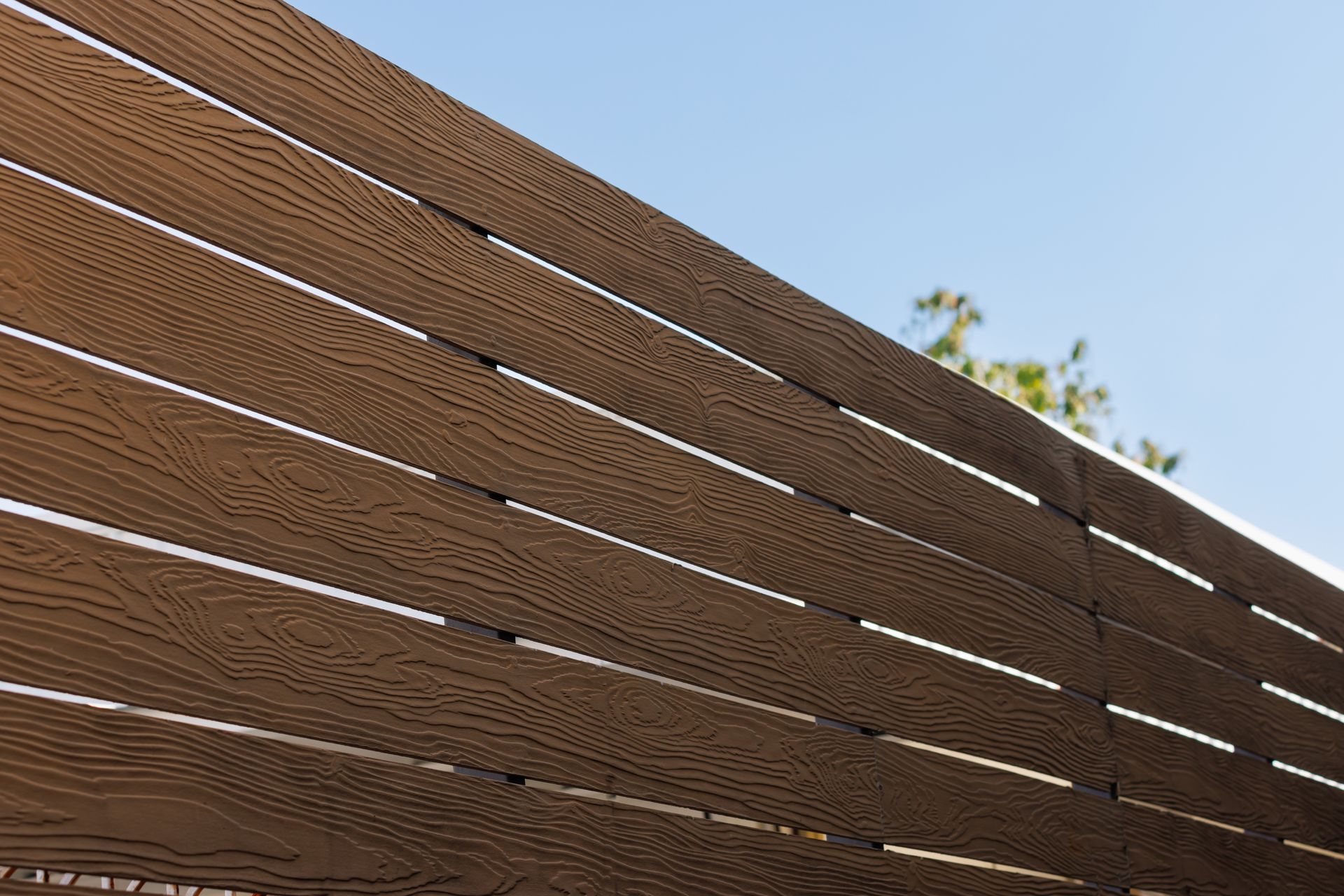 Wooden Slatted Fence or Shade Screen Against a Clear Blue Sky — Master Glass & Glazing in Newcastle, NSW