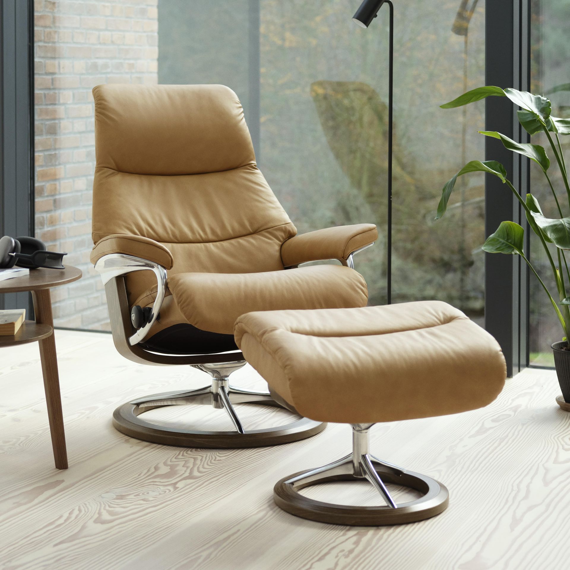 Stylish leather recliner with a foot rest(that you can customize at Eagles' Rest)sitting in a high-end living room.