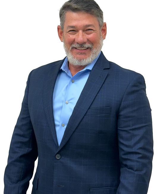 Man in blue suit, smiling, standing in front of white background.