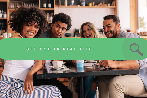 Four friends at a cafe table smiling, text overlay 