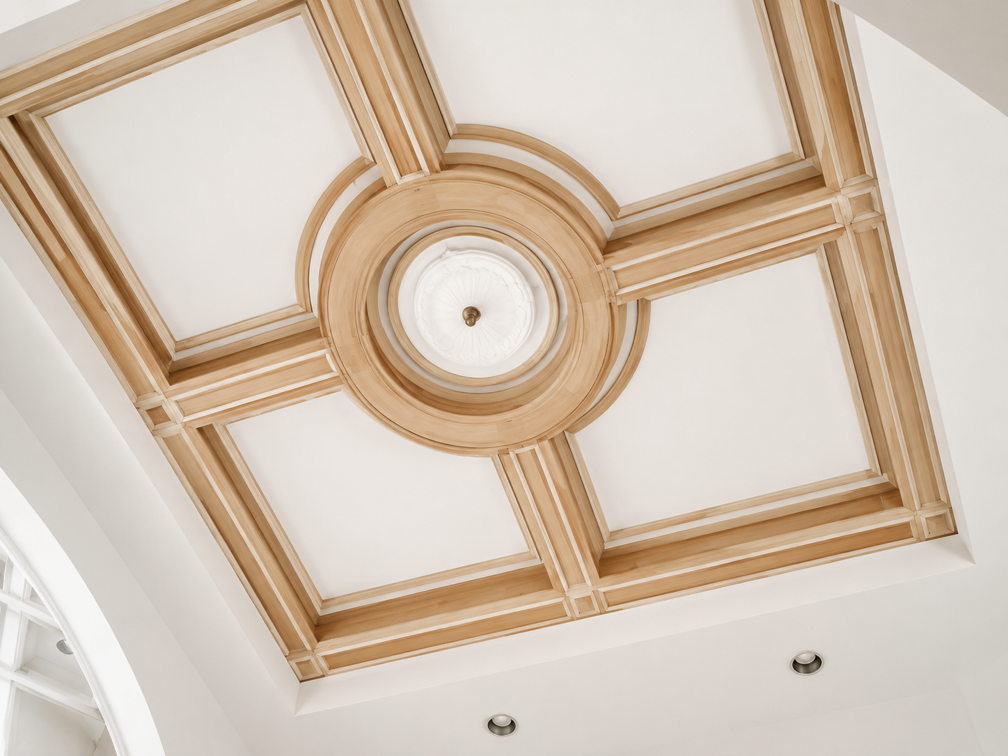 Decorative coffered ceiling with a central circular light fixture and gold trim on white panels