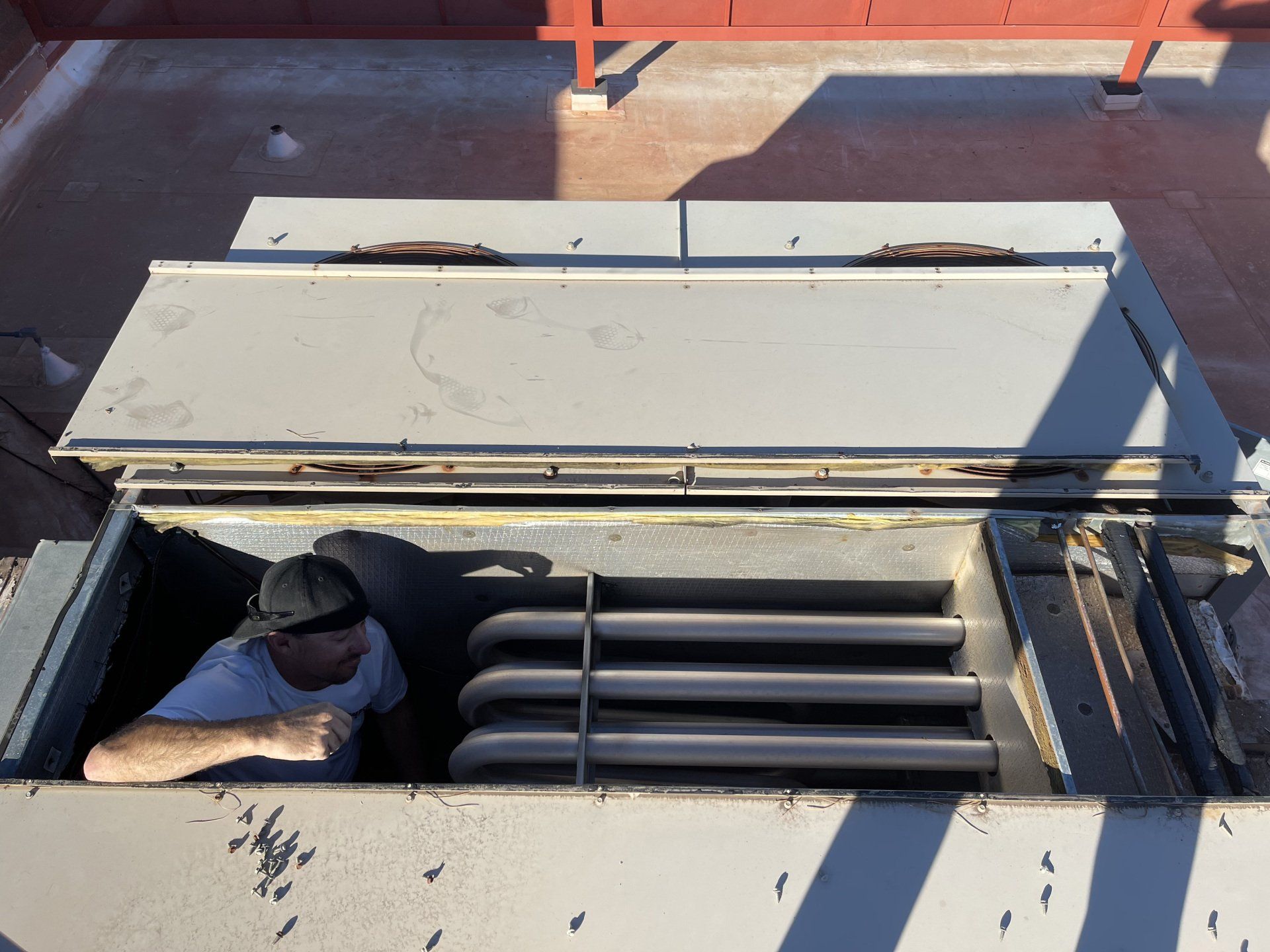 A man is looking out of a hole in a building.