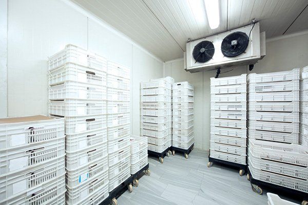 A room filled with lots of white crates and shelves.