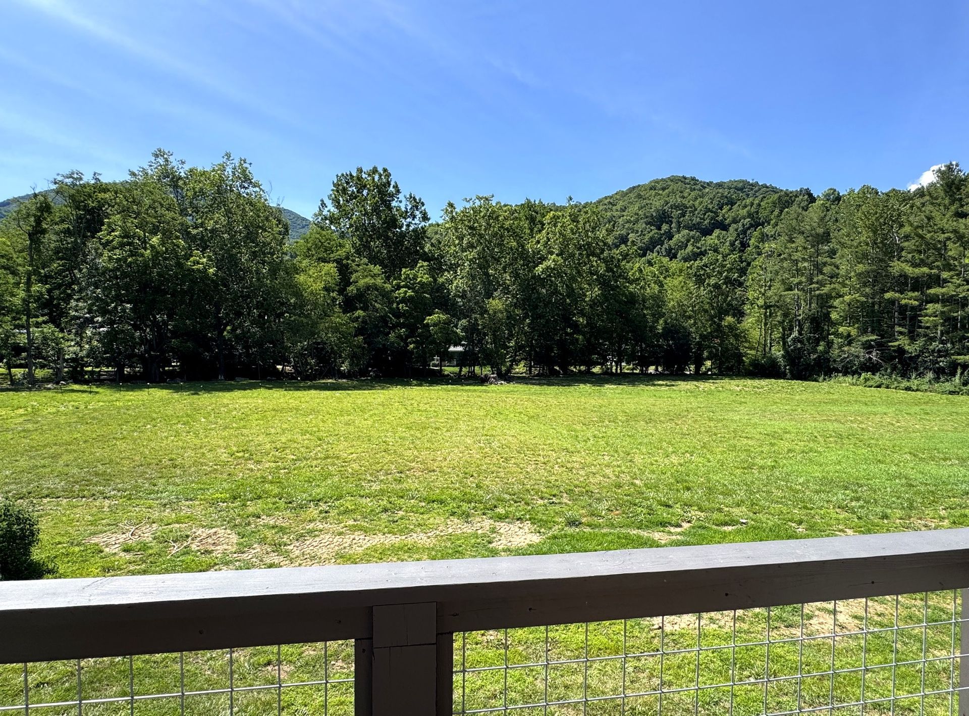 Mountain and meadow view from a private patio at Fox Run Apartments