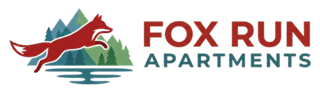 Fox Run Apartments pet-friendly Waynesville NC logo with a leaping red fox and teal mountains.