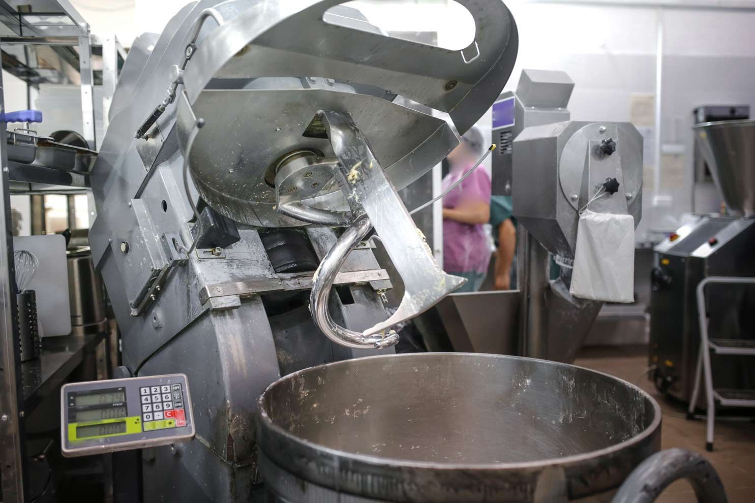 Industrial dough mixer with spiral hook and control panel used in commercial food prep.