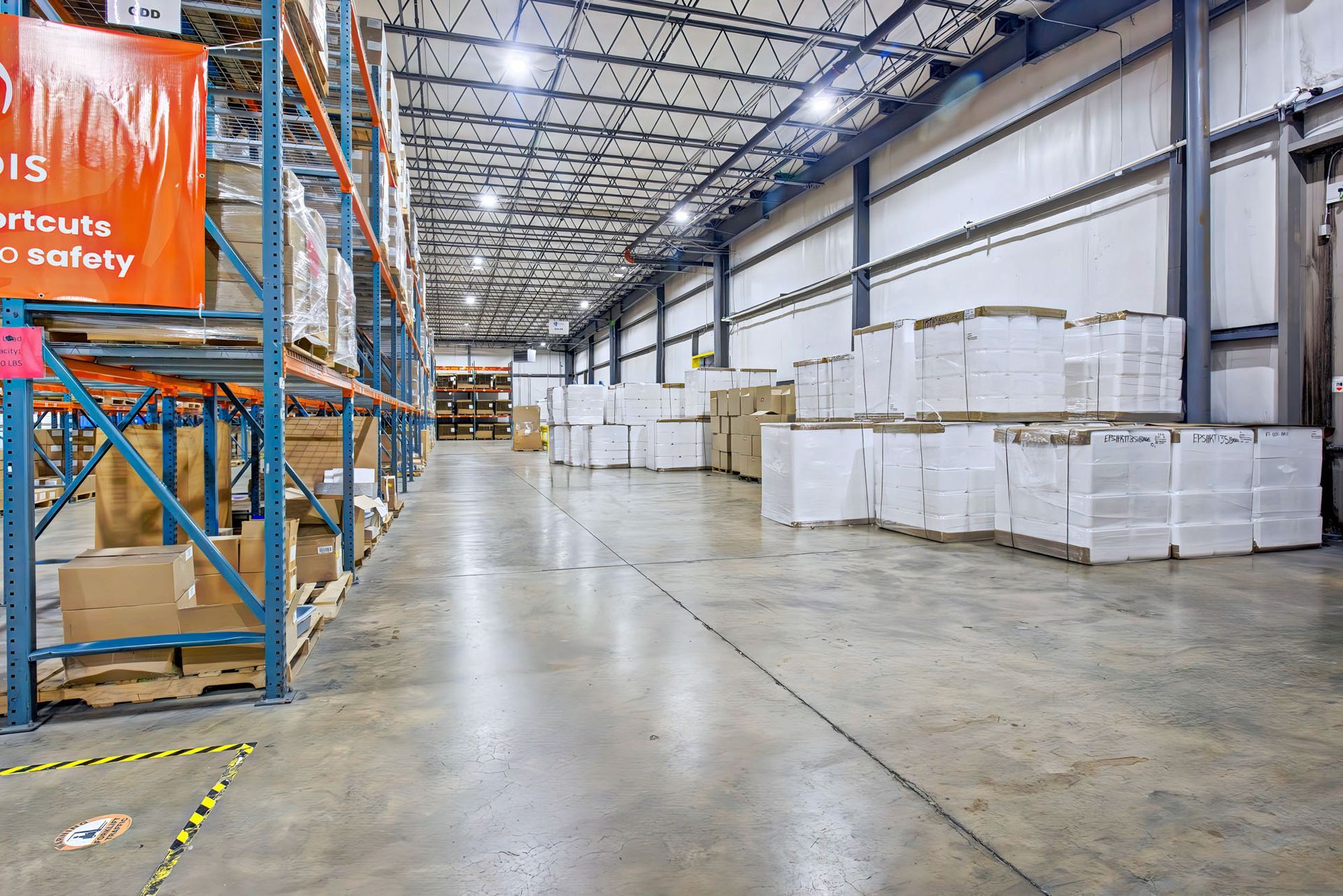 Warehouse showing rack and pallets of items 
