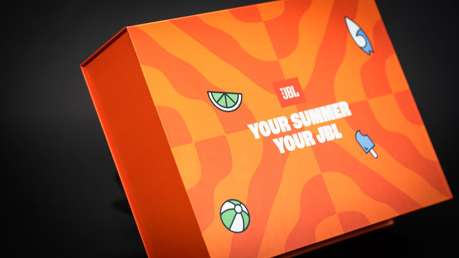 Bright orange JBL PR gift box designed and produced by branded boxes.