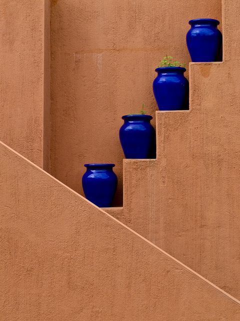 detail of brown intonachino pitted and blue bowls