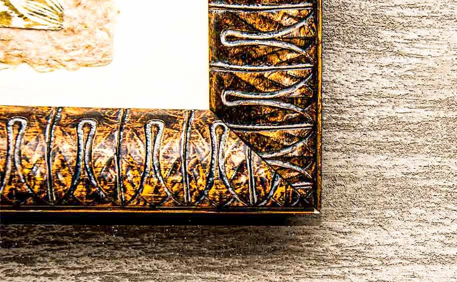 picture of a detail of grey plaster with a gold frame