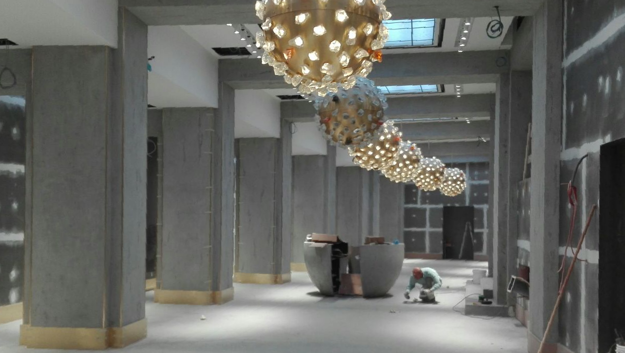 pictures of a work in progress shop center decorated with Venezia Stucco plastering product
