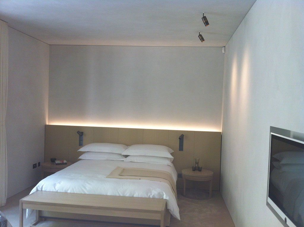 picture of a bedroom with wooden bed and white suede wall and roof product