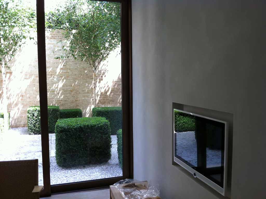 detail of an interior with a big bright window and wooden floor with white suede wall and roof product