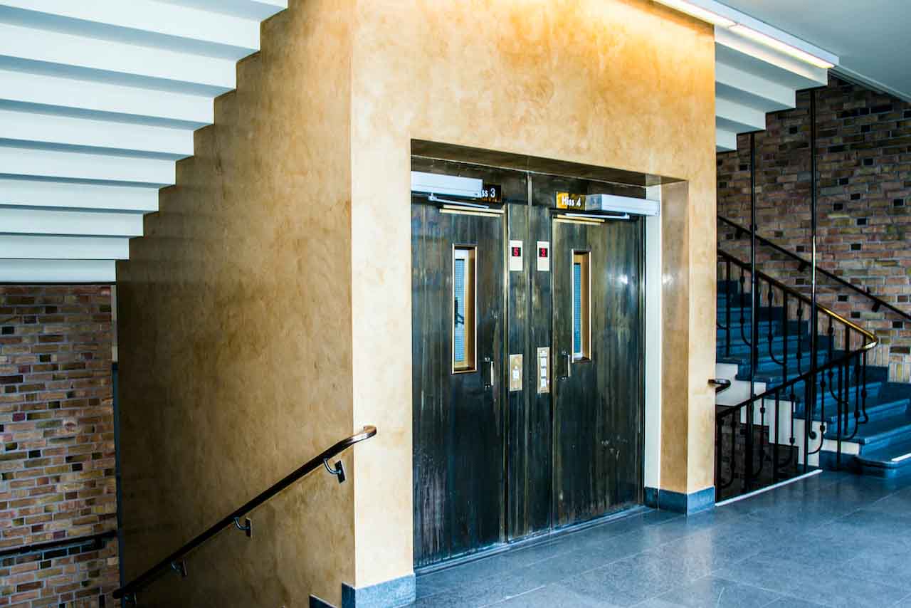 picture of yellow tadelakt product on hotel interior walls and a doubled door