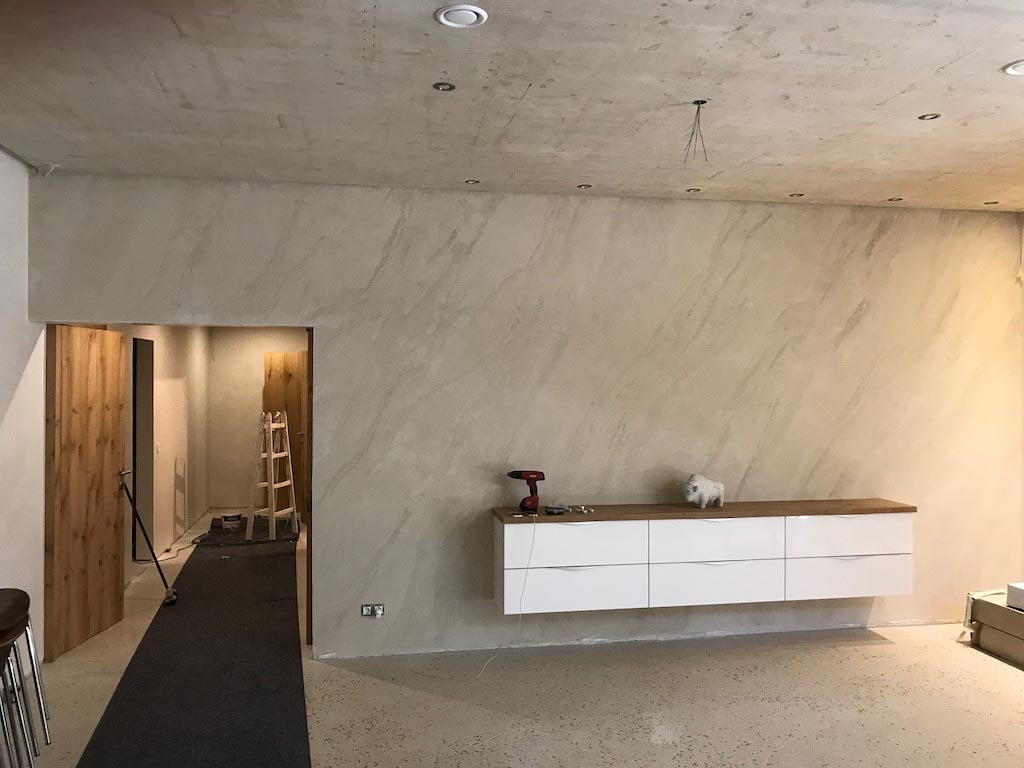 picture of a a big room with grey travertino walls