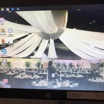 HP laptop desktop with a white draped ceiling wallpaper and icons along the left side