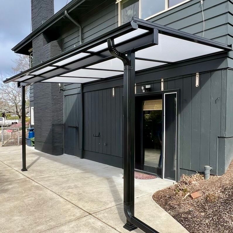 Sleek black-frame Shed Style patio cover with Cool Blue panels installed by Crown Patio Covers in Northwest Portland