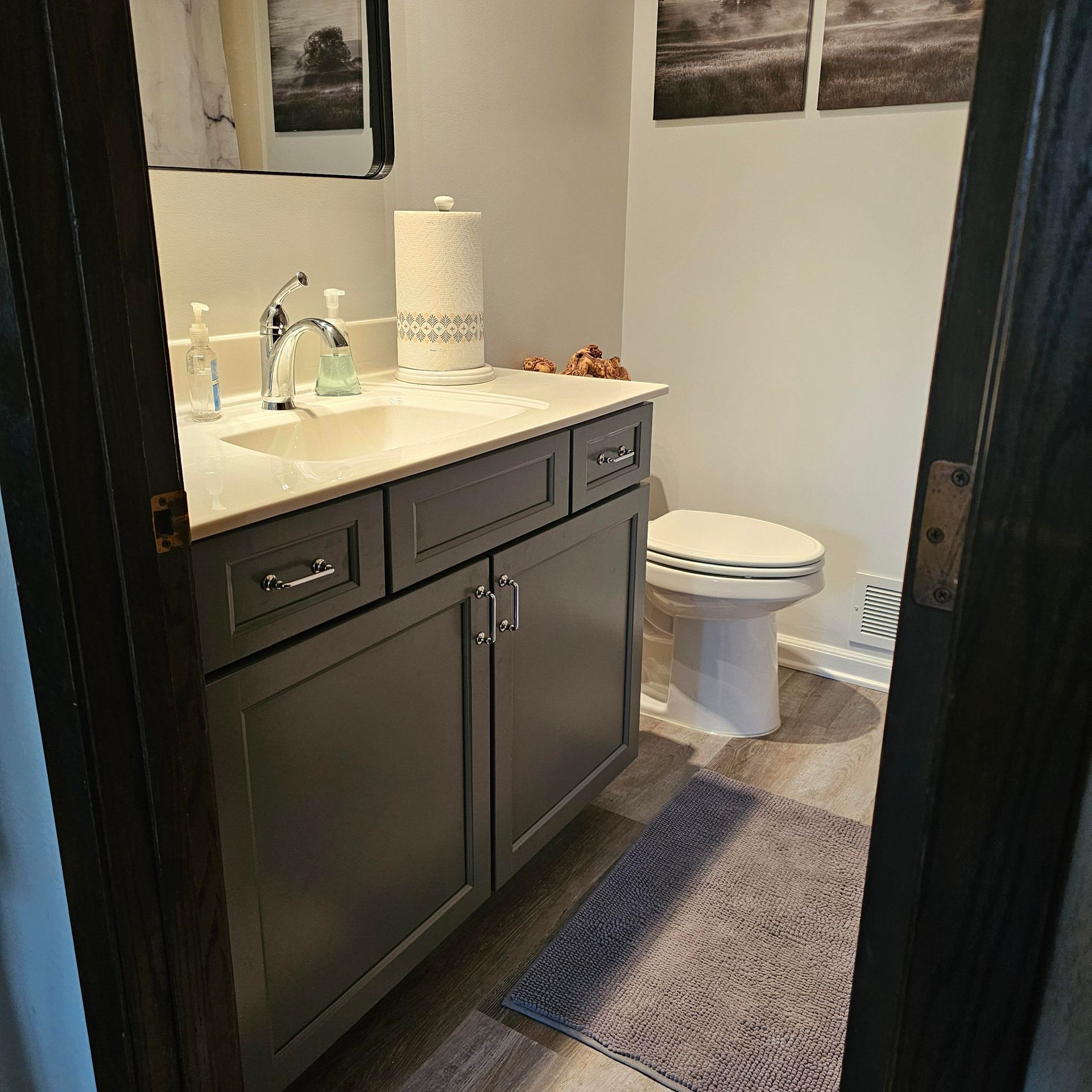 A bathroom with a toilet a sink and a mirror