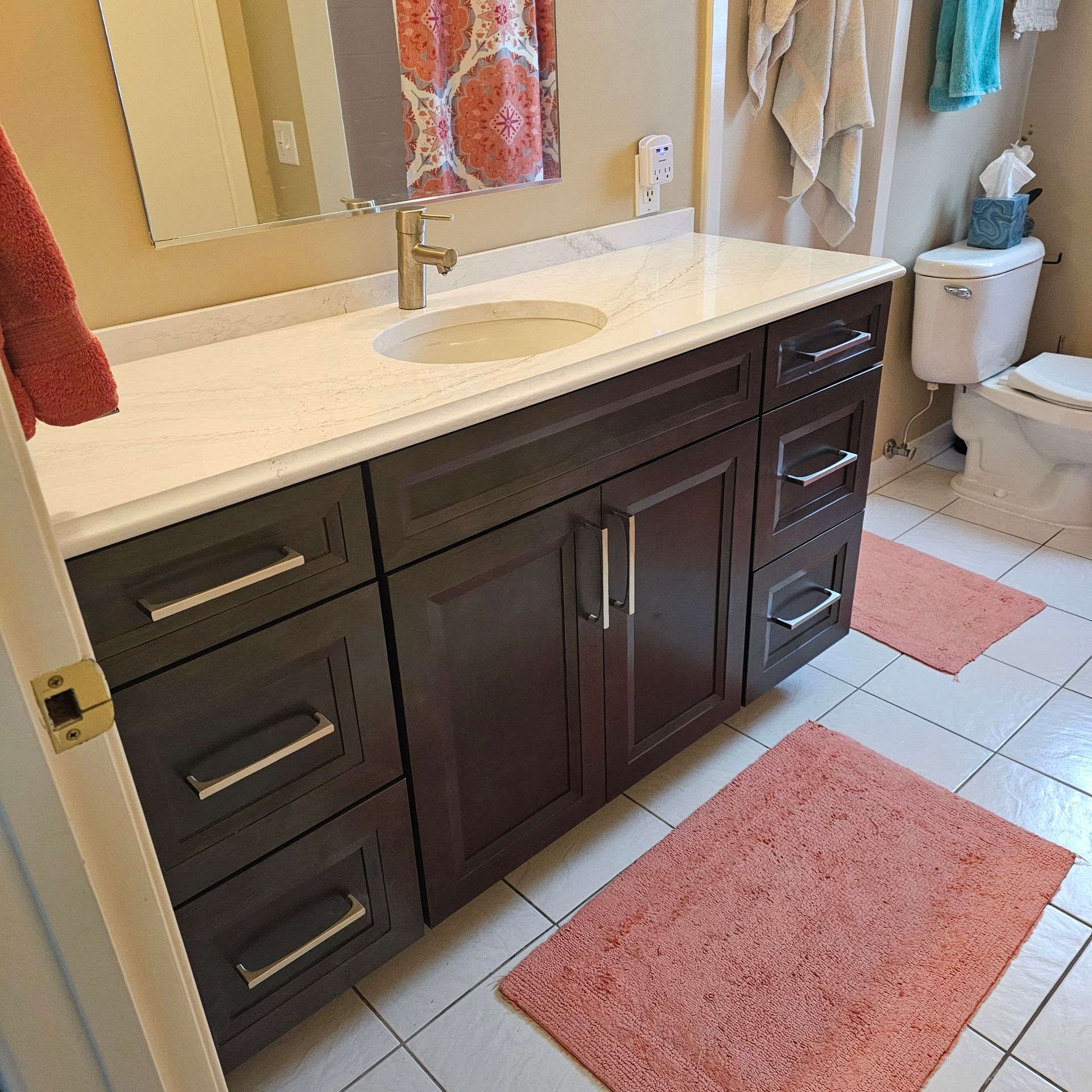 A bathroom with a sink a toilet and a mirror