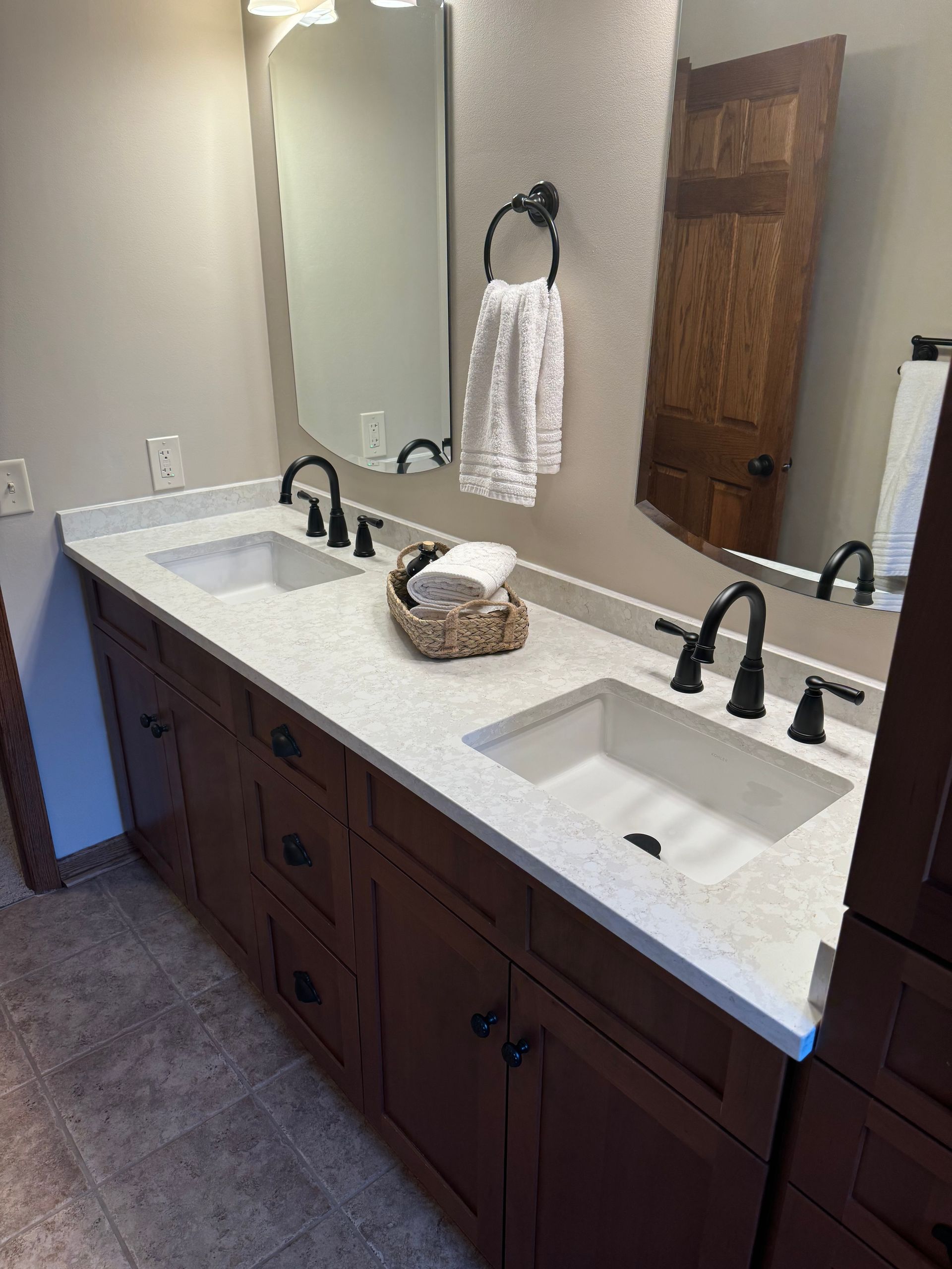 A bathroom with two sinks and a mirror.