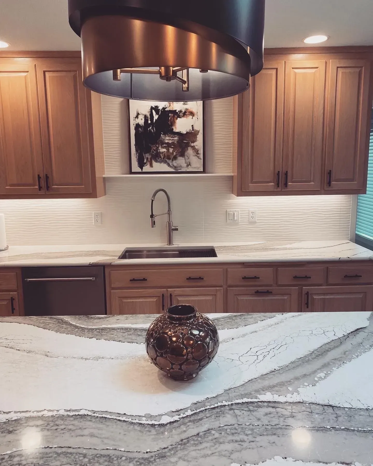 A kitchen with a sink and a vase on the counter