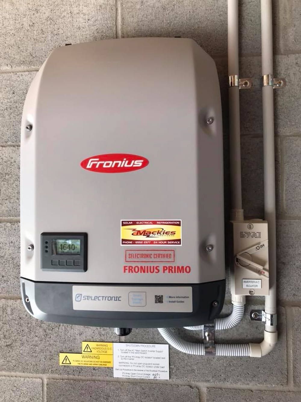 A Fronius Primo Inverter Is Mounted On A Brick Wall — Mackies In Taree, NSW