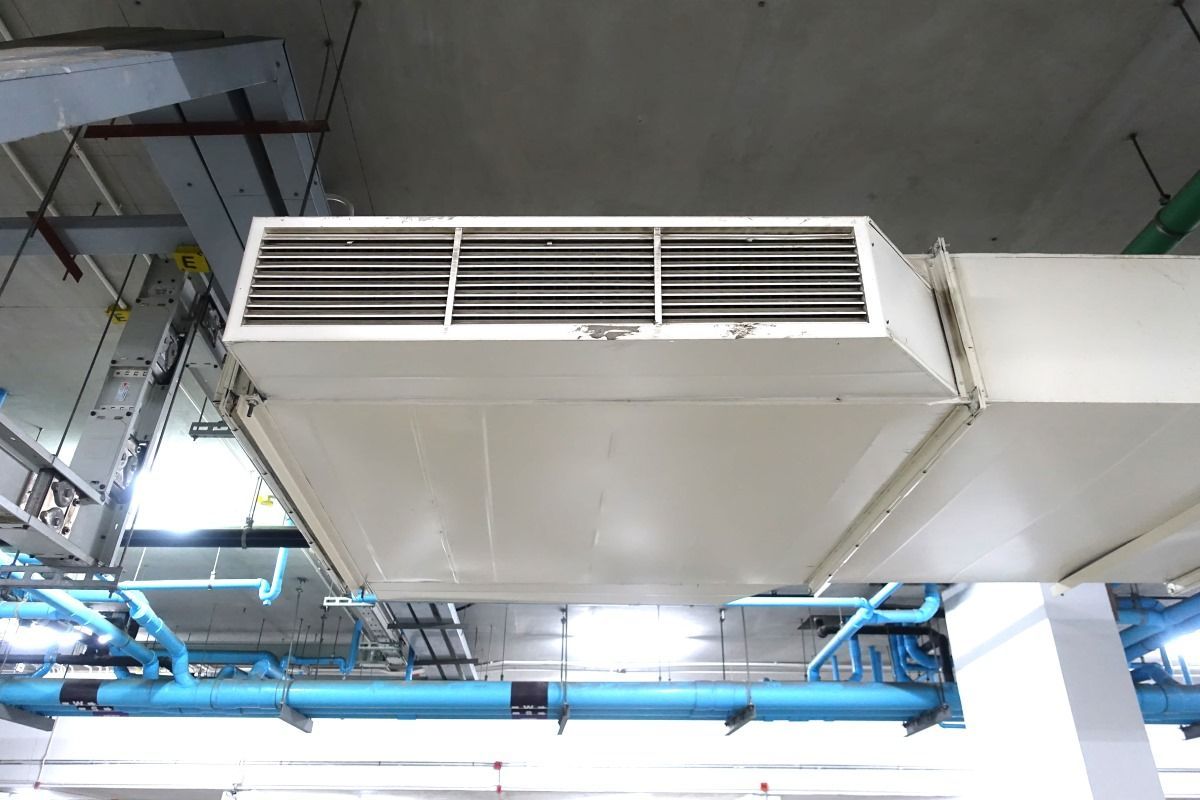 White Rectangular Air Vent Mounted On A Ceiling With Blue Pipes — Mackies In Forster, NSW