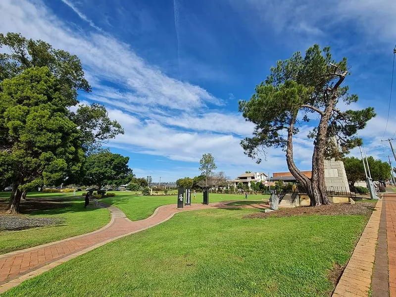 A Park With A Brick Walkway And Trees On A Sunny Day — Mackies In Taree, NSW