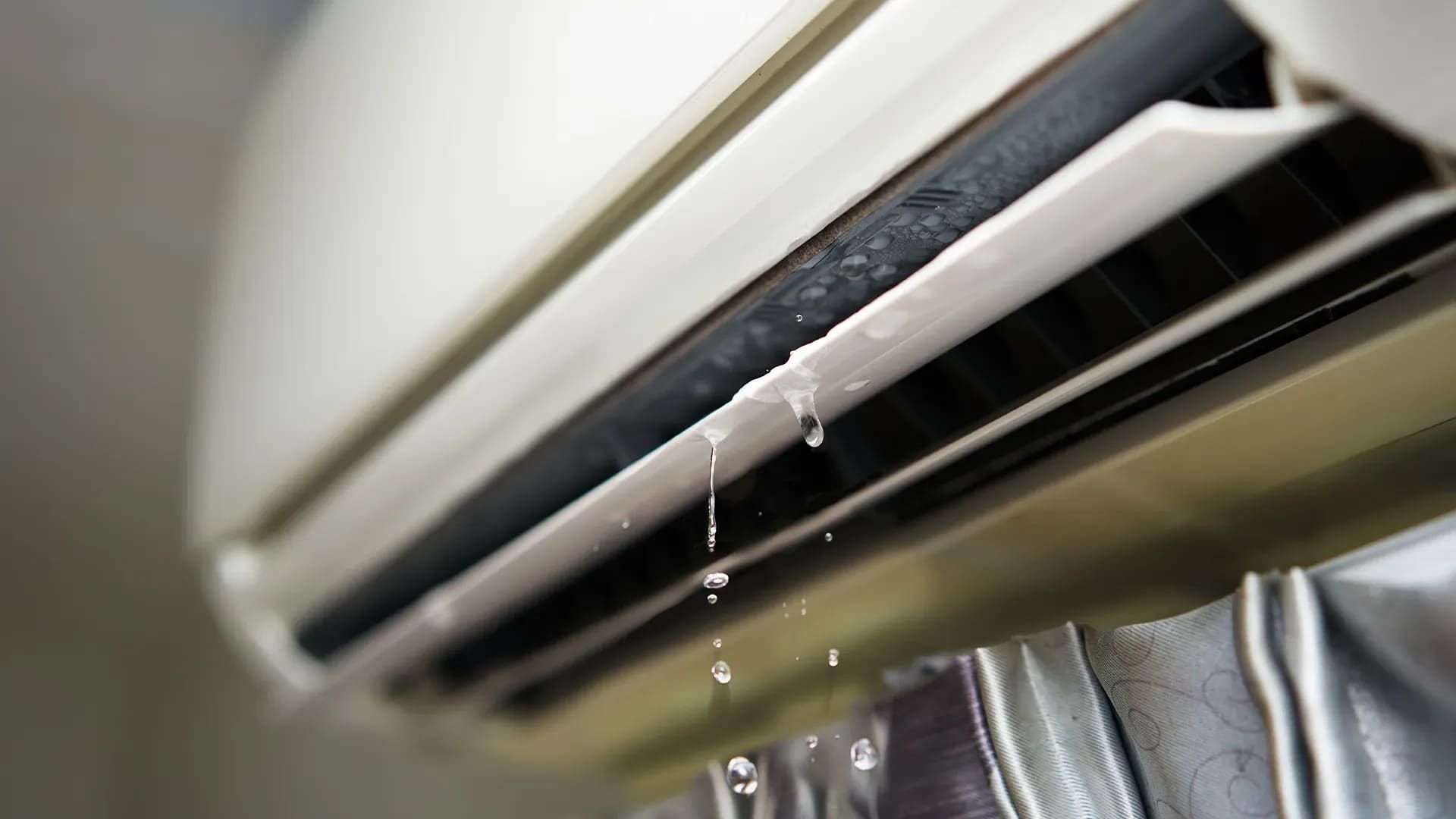 A Close Up Of A Broken Air Conditioner With Water Dripping From It — Mackies In Taree, NSW