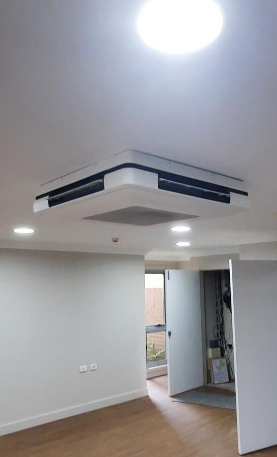 Ceiling-mounted Air Conditioning Unit In A Bright Room — Mackies in Taree, NSW