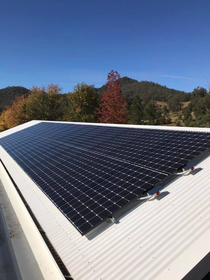 Solar Panels On A White Corrugated Metal Roof — Mackies in Taree, NSW