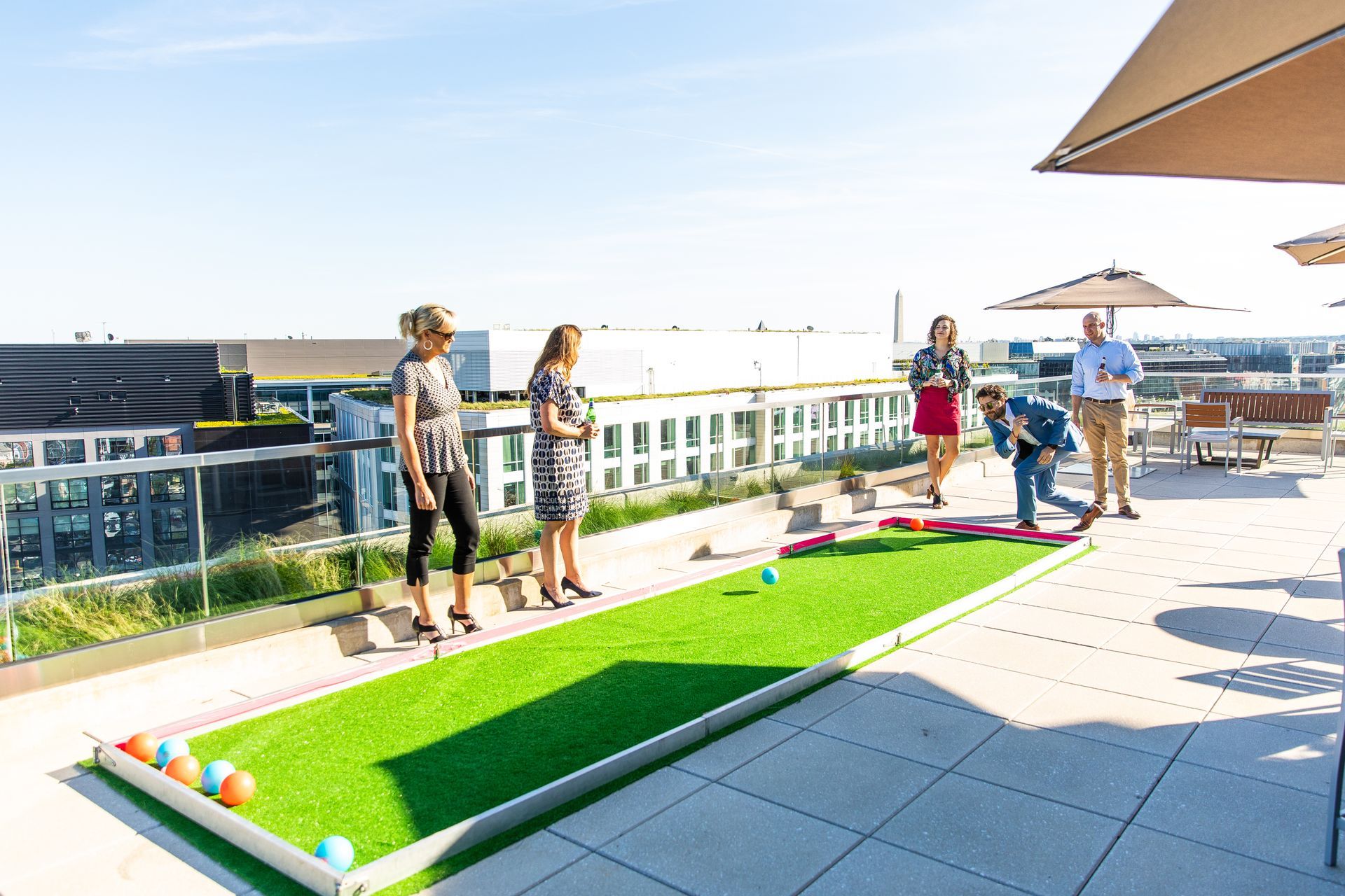 A group of people are playing a game on a rooftop.