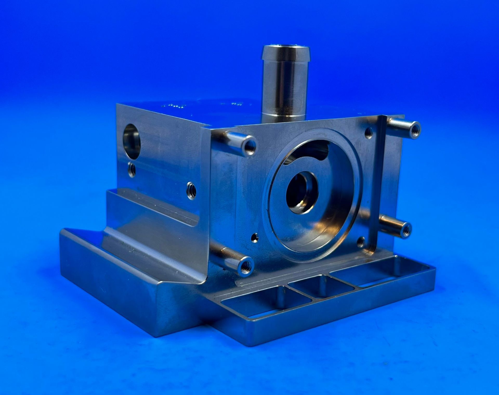 A piece of metal with a hole in the middle on a blue surface