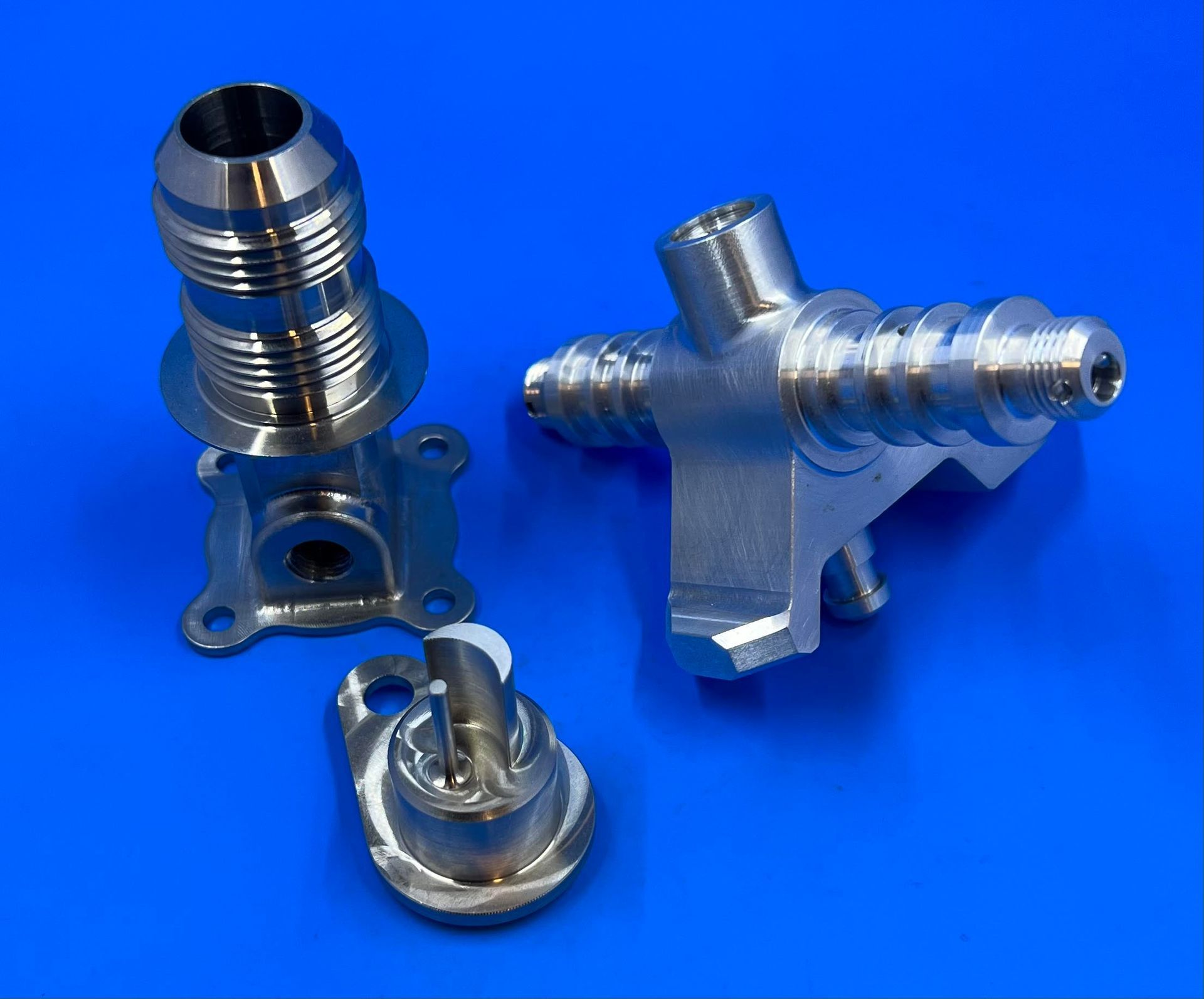 A couple of metal pieces on a blue surface