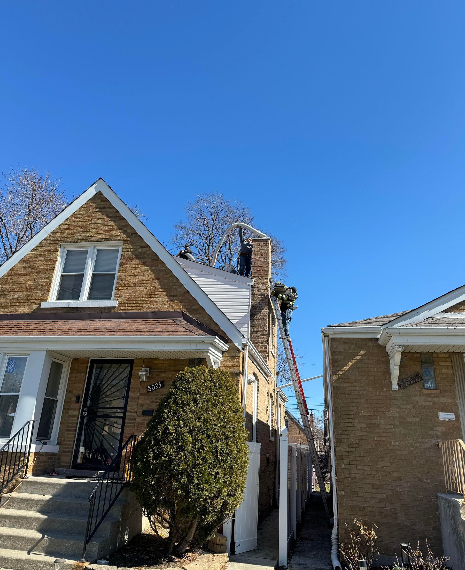 guy on ladder next to roof