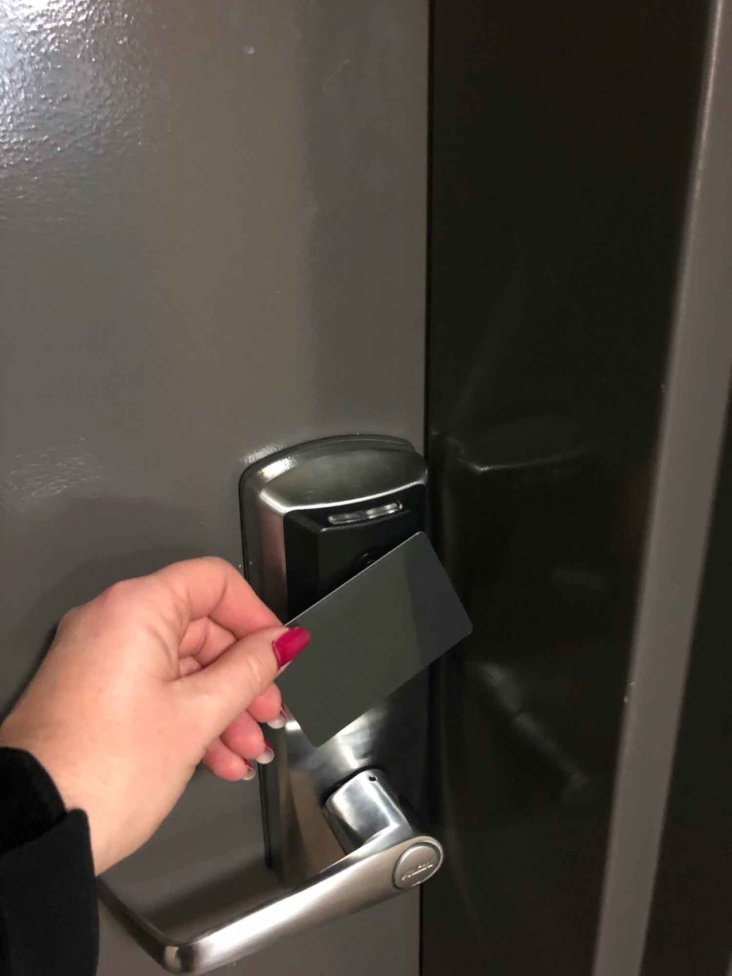 A Person Is Holding A Card In Front Of A Door Lock – Wingfield, SA - On The Spot Locksmiths